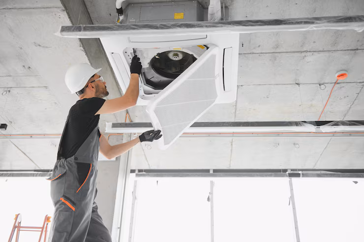 technician-cleans-air-conditioner-system-modern-apartment_255667-72787